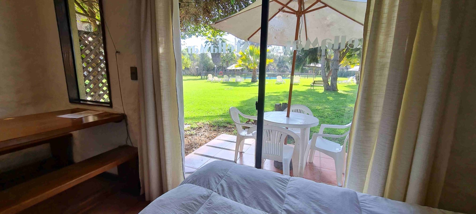 Terraza con quitasol frente al jardín